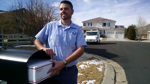 Letter Carrier JD Kohl demonstrates the capacity of the new mailboxes.